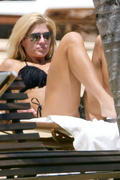 Torrie Wilson - wearing a bikini at a pool in Miami 04/11/13